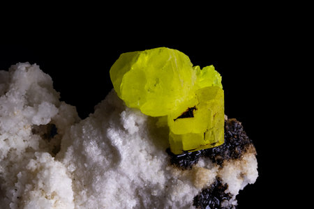 Close-up of green and yellow tourmaline on black background