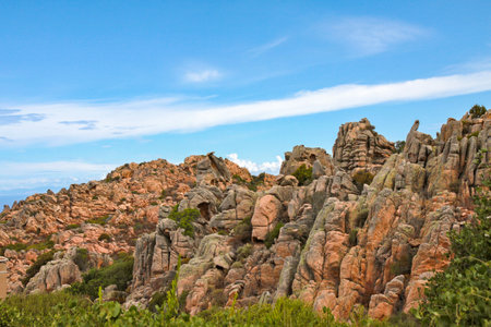 Rocky landscape with blue sky and white clouds in Sardinia, Italyの写真素材