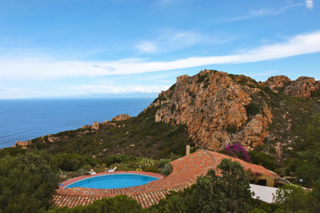 Swimming pool on the edge of a cliff in Corsica, Franceの写真素材
