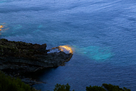 Lonely island in the sea at sunsetの写真素材