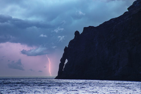 Stormy sky over the sea and the rock in the foreground.の写真素材
