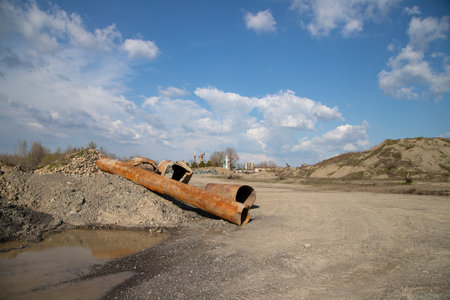 Concrete pipe in the sand against the background of the blue skyの写真素材