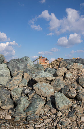Old stone house with blue sky and white cloudsの写真素材