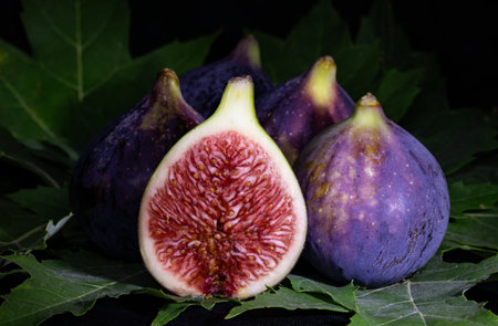 Ripe figs on a black background. Close-up.
