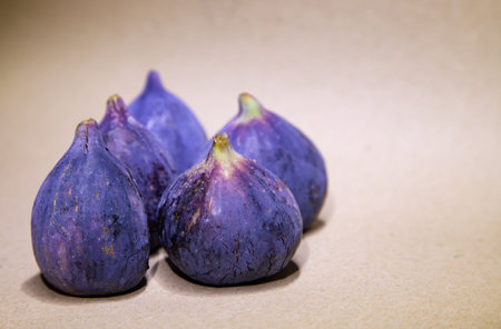 Fresh figs on a brown background. Selective focus. Toned.