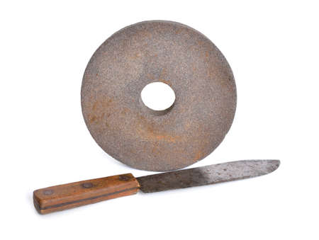 Vintage knife with Old abrasive wheel isolated on white background.の写真素材