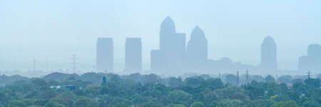 Foggy cityscape panorama with highrise buildings on a rainy day の写真素材