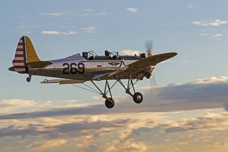 Airplane vintage Ryan PT-22 Recruit landing into sunsetのeditorial素材