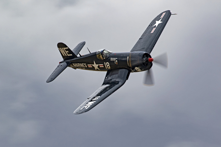 Airplane F4-U Corsair vintage WWII fighter flying at air showのeditorial素材