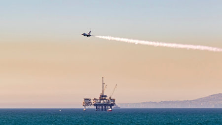 Jet fighter flying above California oil rig