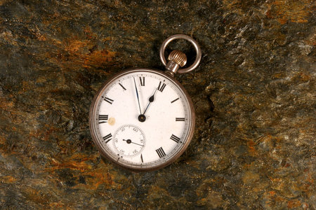 Antique pocket watch on rock