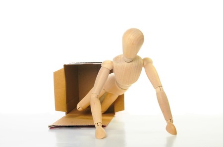 Artists mannequin crawls out of a boxの写真素材