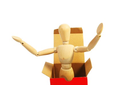 Artists mannequin emerges from a box arms outstretchedの写真素材