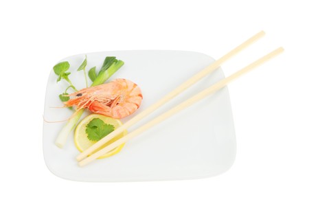 Whole shell on prawn with garnish and chopsticksの写真素材