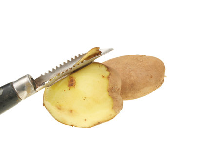 Peeling a potato isolated on whiteの写真素材