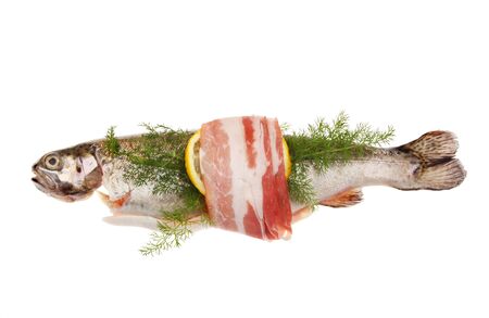 Trout wrapped with pancetta, lemon and fennel isolated against whiteの写真素材