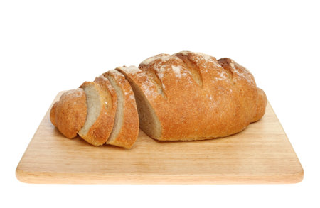 Fresh home baked bloomer bread loaf with slices cut on a wooden board isolated against white