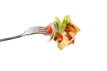 Quiche and salad on a fork isolated against white