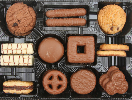 Assortment of sweet biscuits in a plastic trayの写真素材