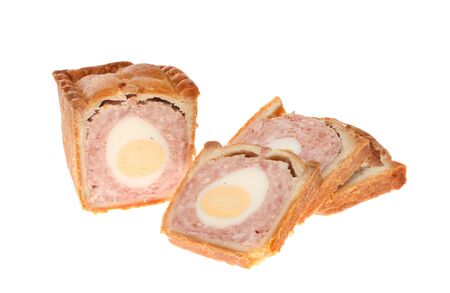 Pork and egg pie with cut slices isolated against whiteの写真素材