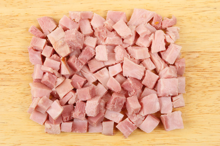 Diced ham on a wooden board viewed from aboveの写真素材