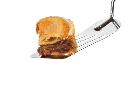 Portion of steak pie on a food slice isolated against whiteの写真素材