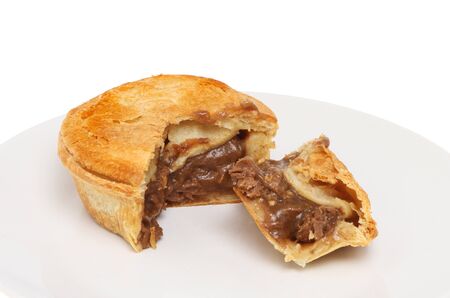 Steak pie on a plate with a slice cut outの写真素材