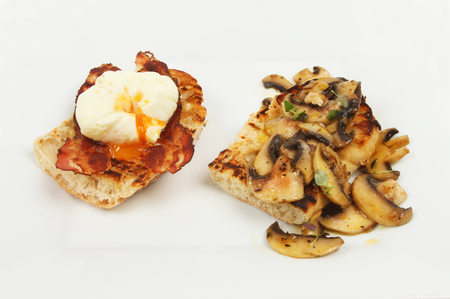 Poached egg and pancetta with fried mushrooms on toasted ciabatta breadの写真素材