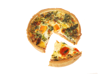 Mediterranean vegetable quiche with a slice cut out isolated against whiteの写真素材