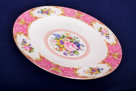 China dinner plate on a blue tableclothの写真素材