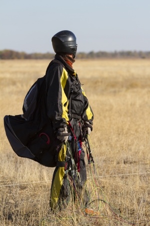 A male paraglider pilot right after landingの写真素材