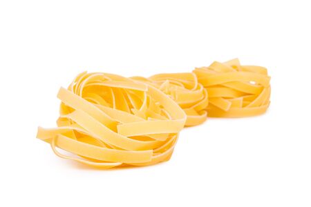 Italian pasta  tagliatelle, isolated on white backgroundの写真素材