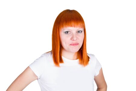 Portrait of a beautiful young redheaded woman looking happy against white backgroundの写真素材