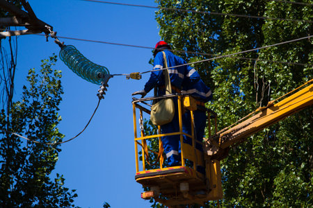 Electrical workers on the lift  Repairing lines
