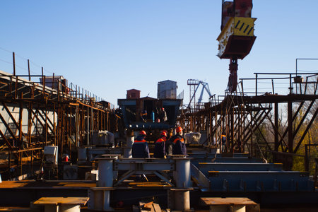 Construction workers of the bridge over the river