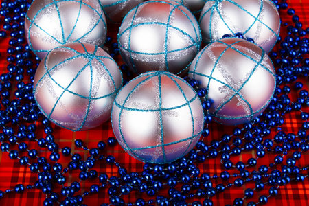 Silver Christmas balls on a red backgroundの写真素材