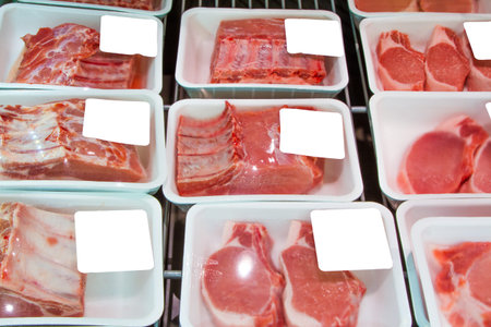 Variety of meat slices in boxes in supermarket