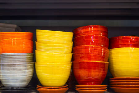 New colored flowerpots in a shelf in a marketの写真素材