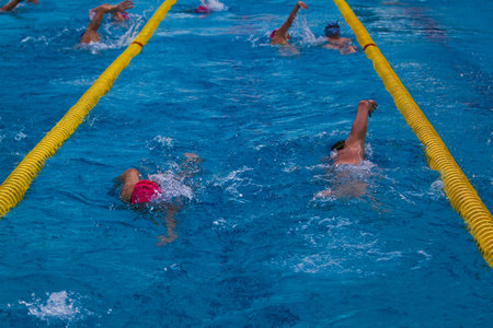 Professional swimmer in the pool. Summer sunny day