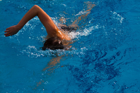 Professional swimmer in the pool. Summer sunny dayの写真素材