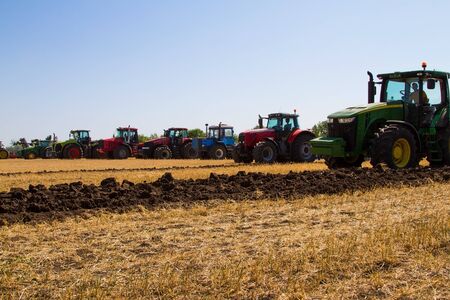 Agricultural tractor plowing a field before sowingの写真素材