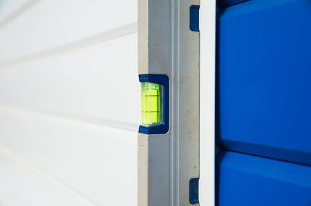 Check the evenness of the wall using a level. At the construction site.の写真素材