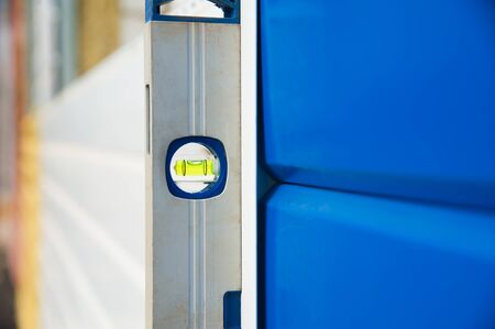 Check the evenness of the wall using a level. At the construction site.の写真素材