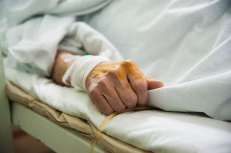 Focus on the hand of a patient in hospital wardの写真素材