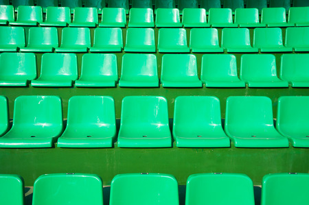 Tribune of fans at the stadium. Empty green seats in stadiumの写真素材