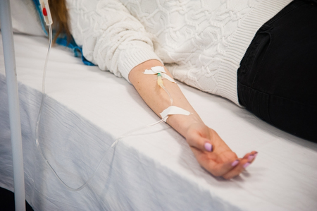 Focus on the hand of a patient in hospital wardの写真素材