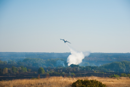 Firefighter airplane extinguishes a forest fire. Landscapeの写真素材