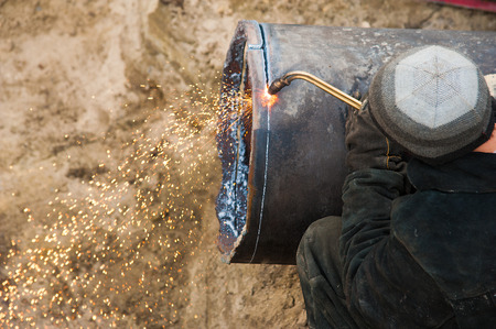 Street reconstruction site of district heating system pipeline and replacement of old pipes with new onesの写真素材