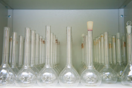 Chemical industry bulb with blue magenta pink liquid lab tubes stand on the table in the laboratory