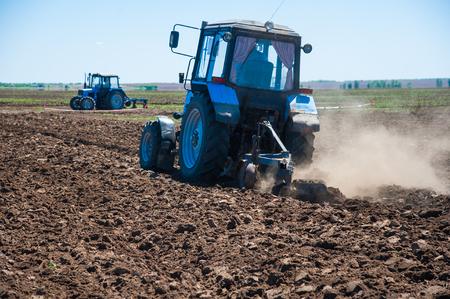 Tractor plowing fields - preparing land for sowingの写真素材